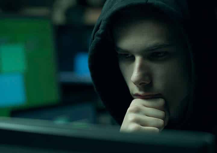 hacker with hoodie working with computers hacker with hoodie working with computers