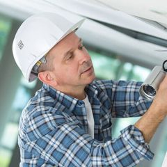 man installing a security camera system
