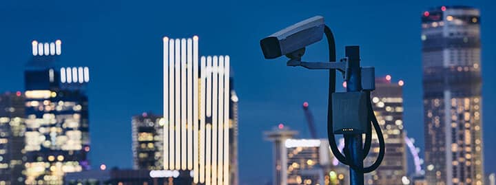 security camera against urban skyline security camera against urban skyline