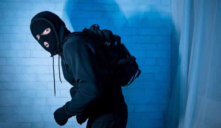 sneaky scared robber ready to steal something at night sneaky scared robber ready to steal something at night