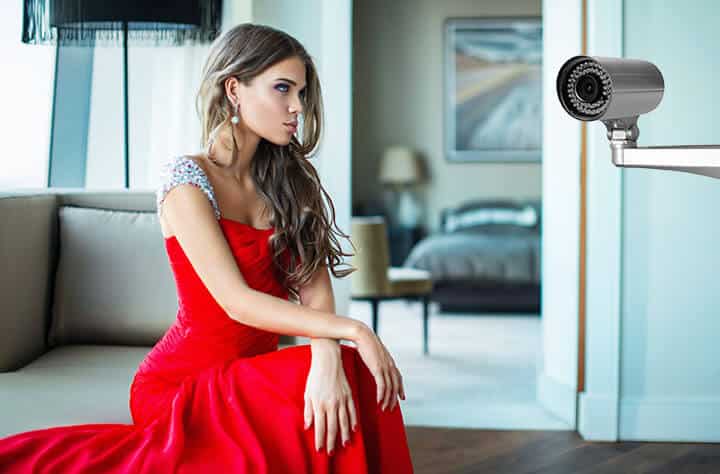 Woman looking at a security camera Woman looking at a security camera