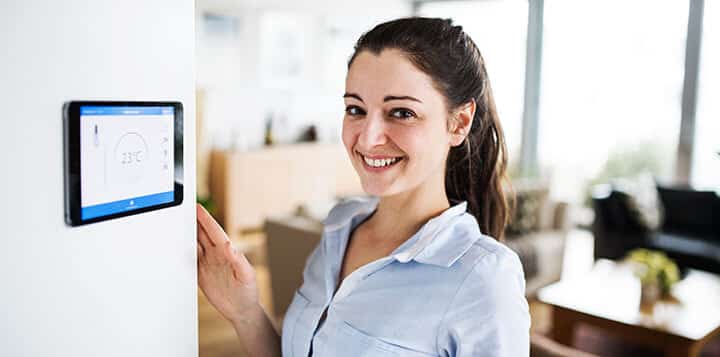 woman looking at tablet with smart home screen woman looking at tablet with smart home screen