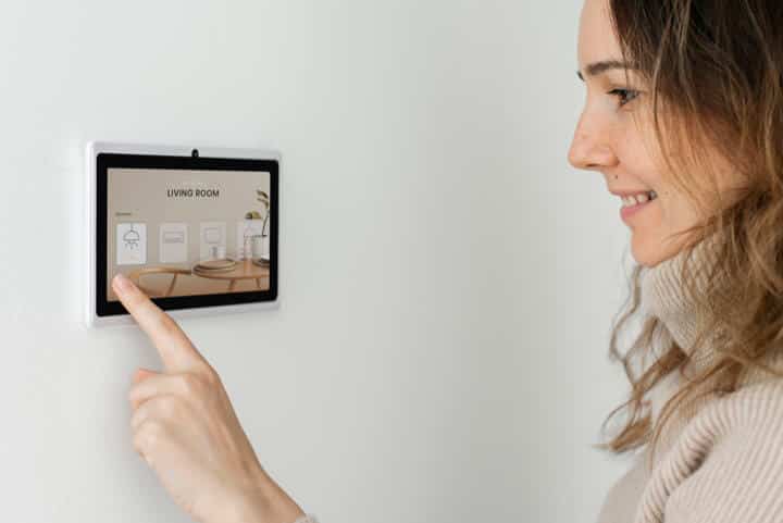 Woman pressing alarm panel buttons Woman pressing alarm panel buttons